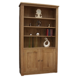 Oak bookcase with three shelves, lower cabinet doors, and decorative items displayed