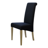 Black upholstered dining chair with high back and light wood legs