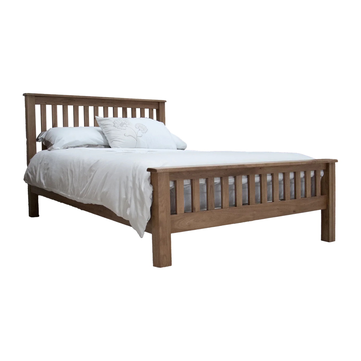 Oak wooden bed frame with slatted headboard and white bedding, side angle view