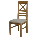 Wooden dining chair with cross back and beige upholstered seat, angled side view