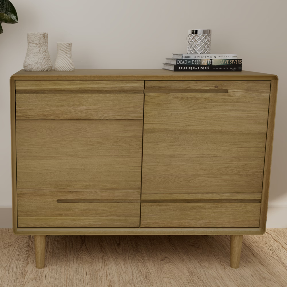 Light wood sideboard cabinet with drawers and shelves, styled with vases and books