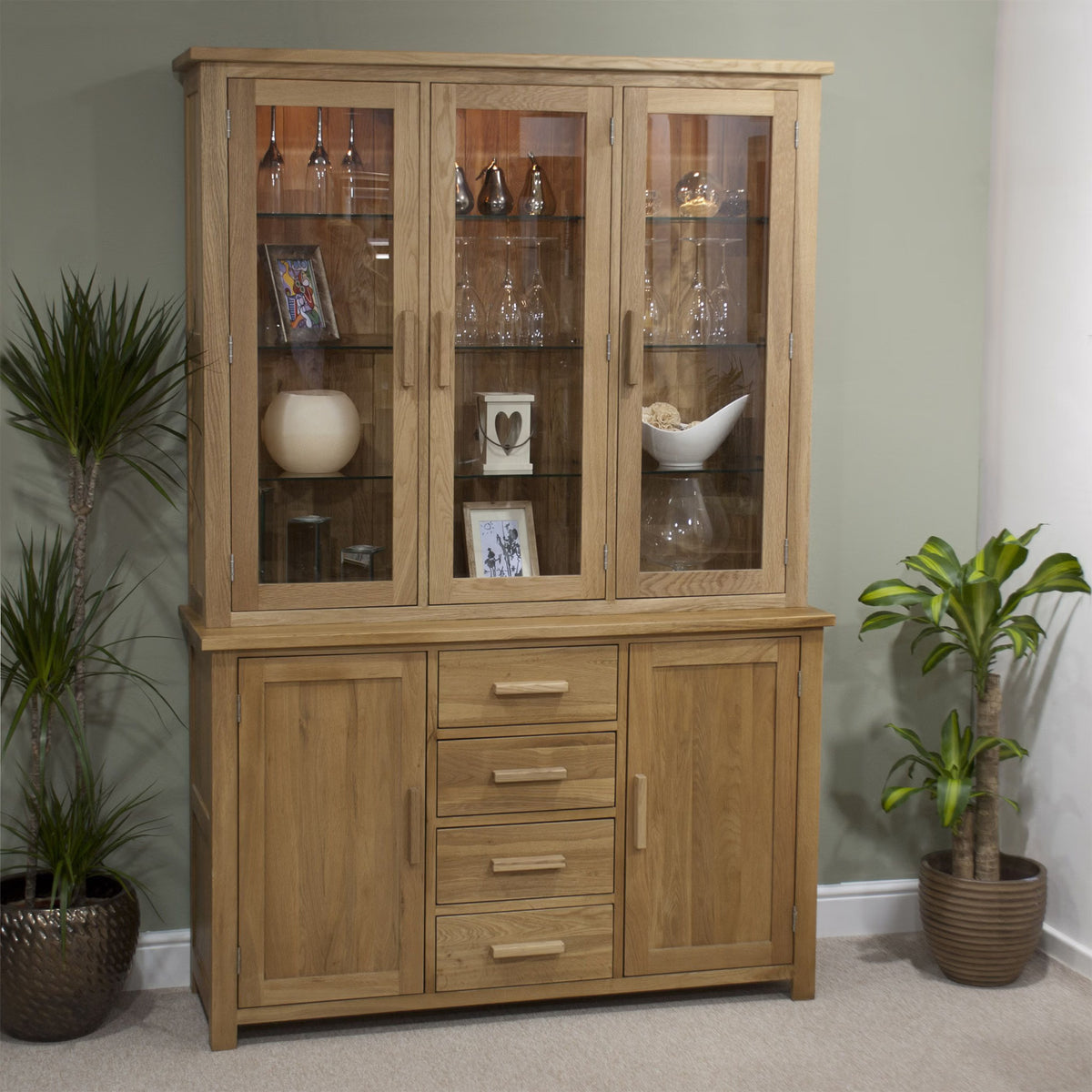 Oak display cabinet with glass doors, drawers and shelves, styled with decor and glassware