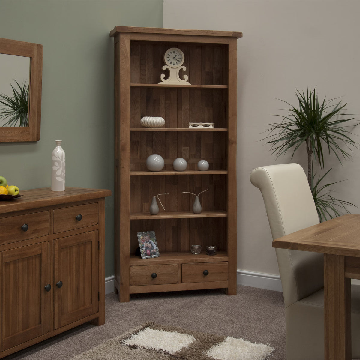 Wooden bookcase with shelves and drawers in dining room, decorated with vases and a clock