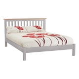 Grey wooden bed frame with slatted headboard and floral bedding in red and white
