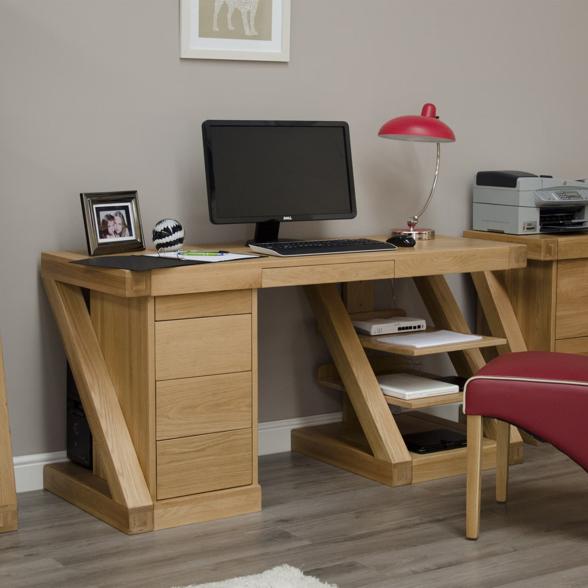 Oak computer desk with drawers and shelves in home office setting