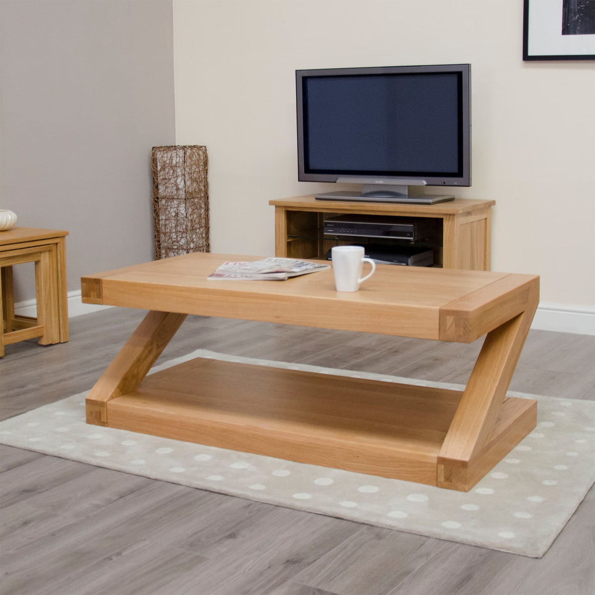 Oak coffee table with magazine and mug on beige rug in modern living room