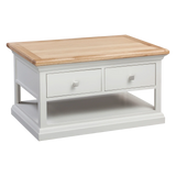 White wooden coffee table with two drawers, oak top, and lower storage shelf