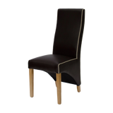 Brown leather dining chair with oak legs and white piping detail, side angle view