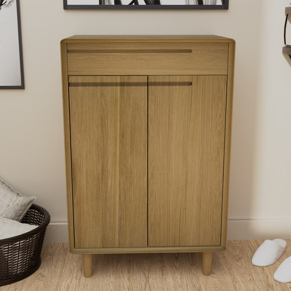 Oak wood cabinet with two doors and a drawer, standing on tapered legs in modern room