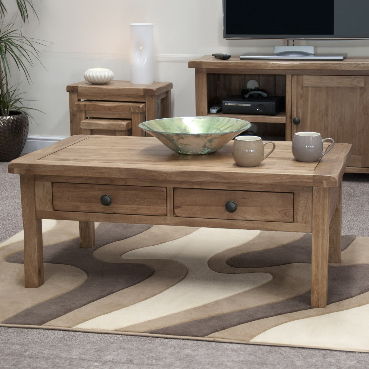 Oak coffee table with two drawers on patterned rug in living room setting