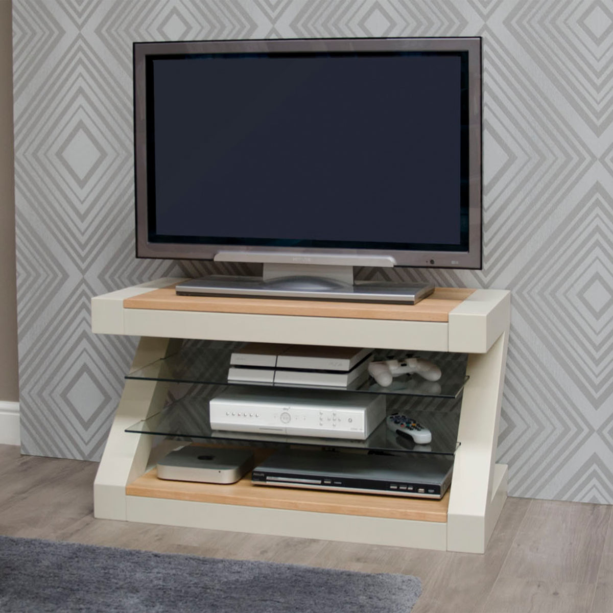 Modern cream and oak TV stand with glass shelves and electronics in living room corner