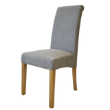 Grey fabric dining chair with wooden legs, side angle view