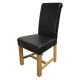 Black leather dining chair with wooden legs and high backrest, angled side view