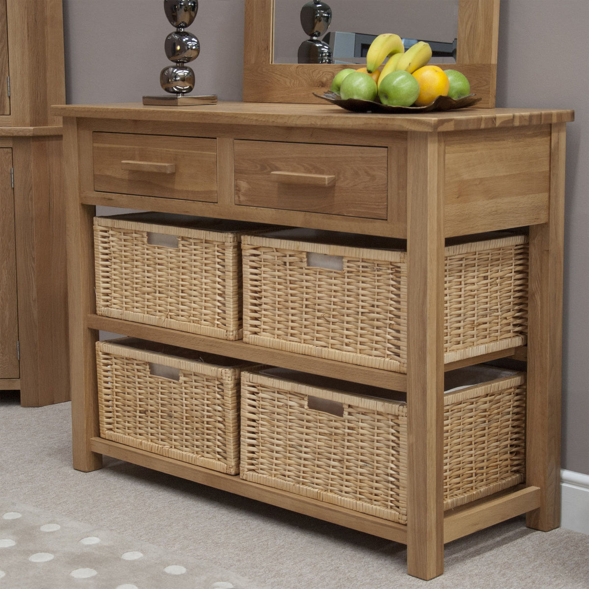 Oak sideboard with two wooden drawers and four wicker storage baskets in a living room