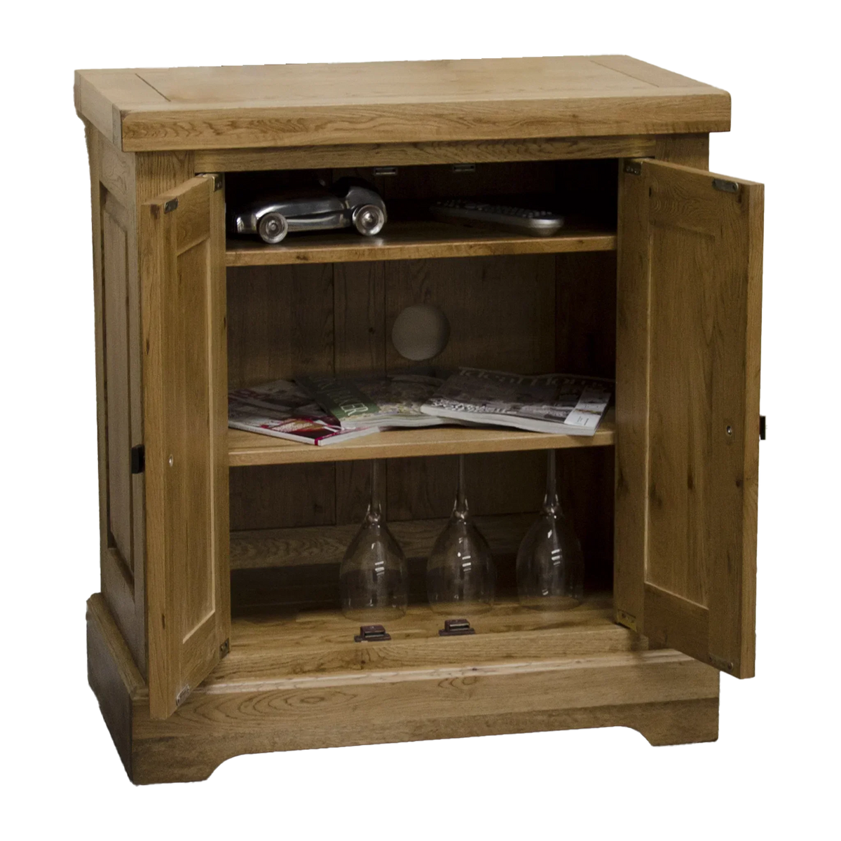 Oak sideboard with shelves, open doors, magazines and wine glasses inside