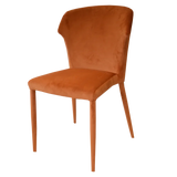 Rust velvet dining chair with cushioned seat and tapered legs, side angle view