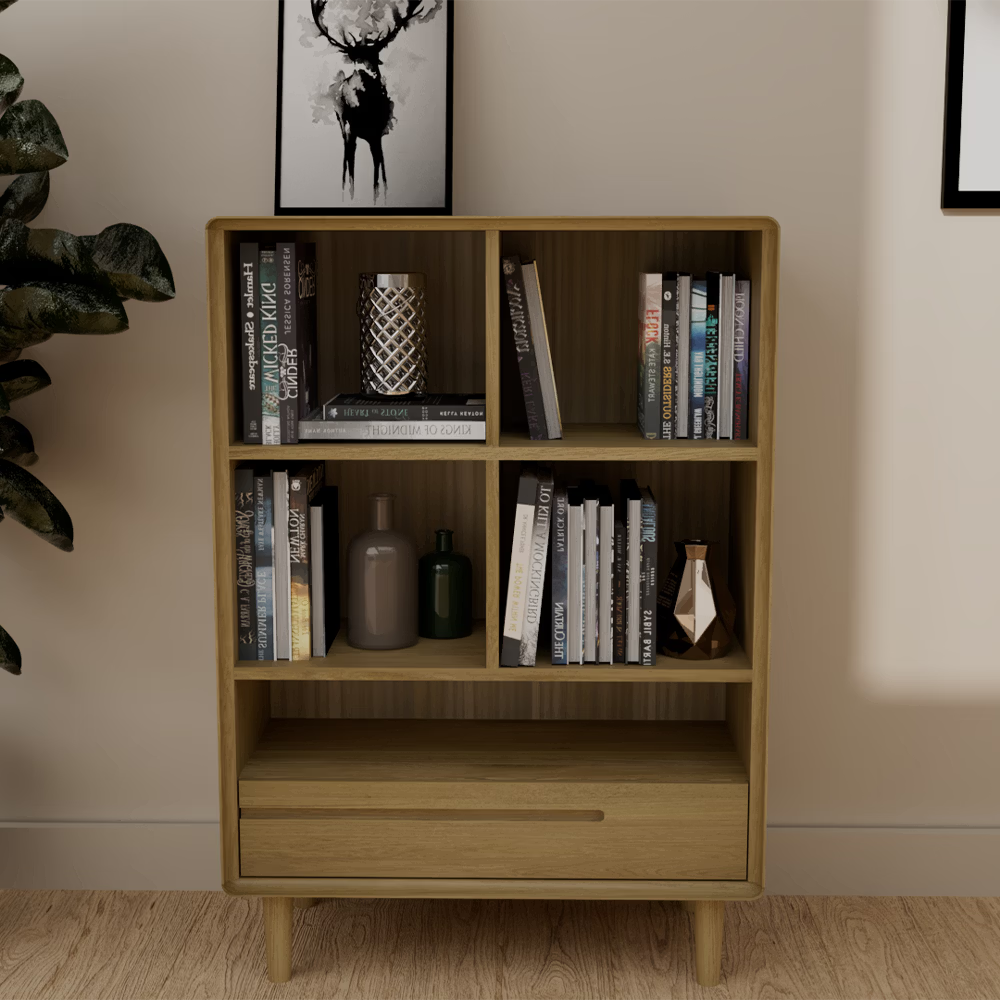 Wood bookcase with shelves and drawer, decorative vases and books in modern living room