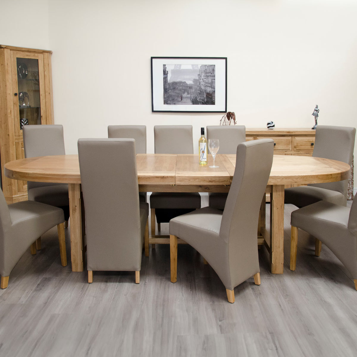 Large oak dining table with extendable leaf and eight grey dining chairs in modern room