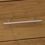 Oak drawer with brushed metal handle in close-up view