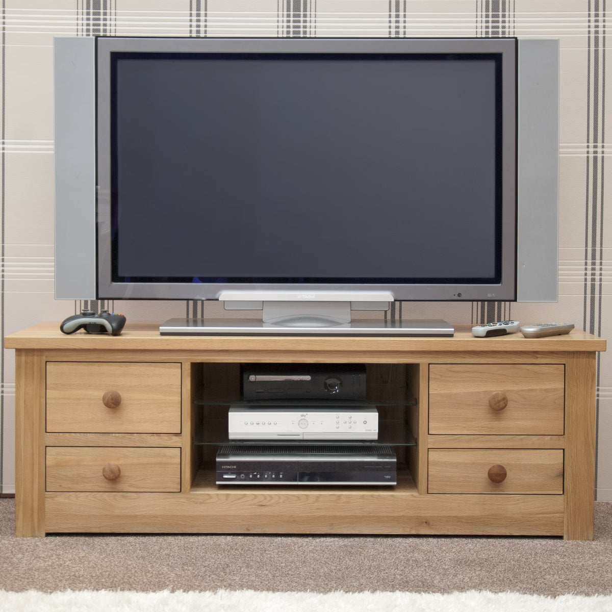 Oak wood TV unit with four drawers and open shelves, modern television on top