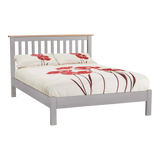 Grey wooden bed frame with slatted headboard and floral duvet cover