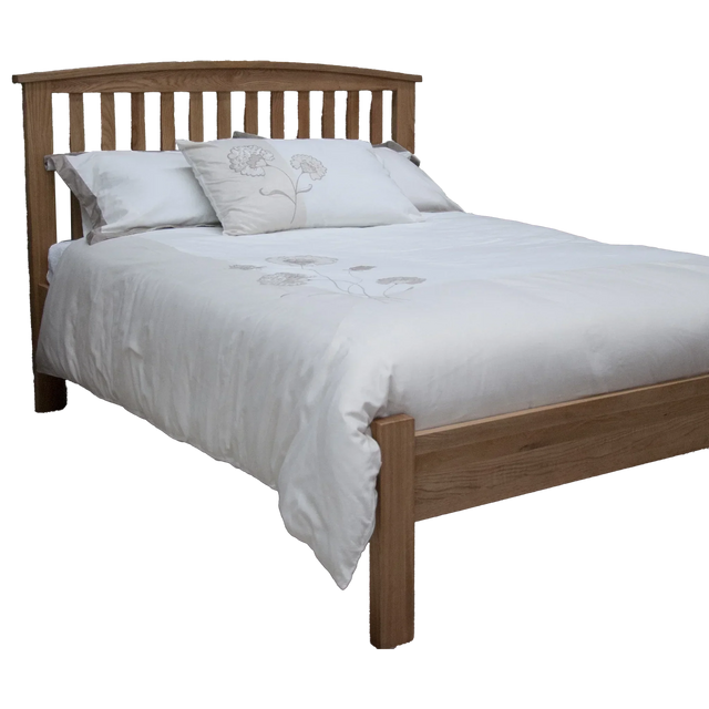 Oak wooden bed frame with slatted headboard and white floral bedding
