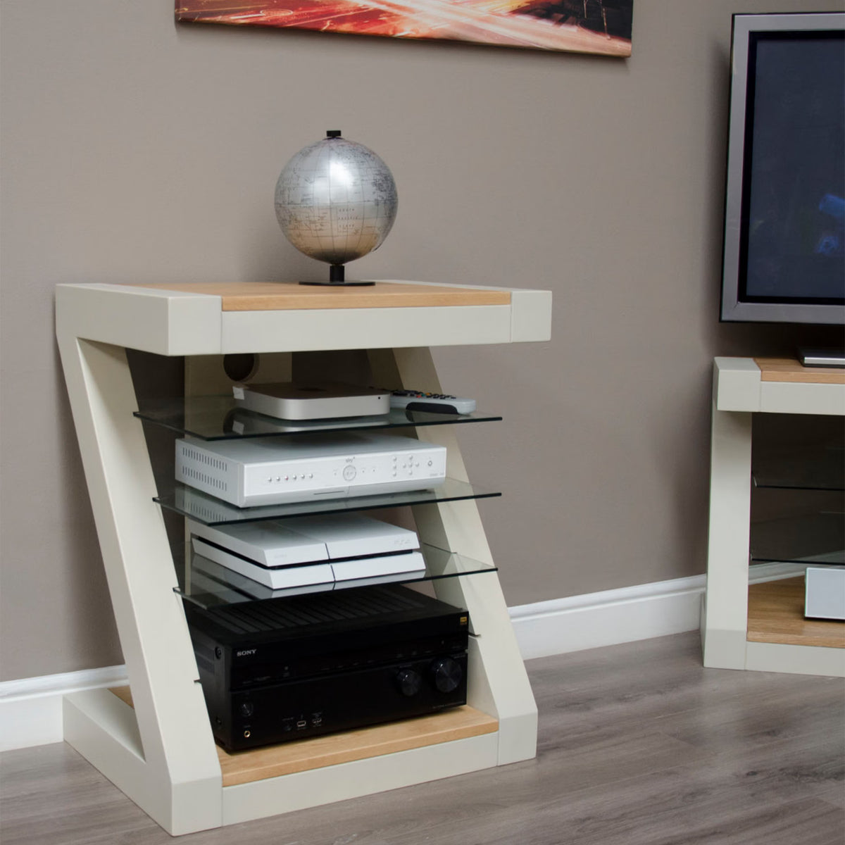 Modern TV stand with glass shelves, white and oak finish, holding electronics and decor globe
