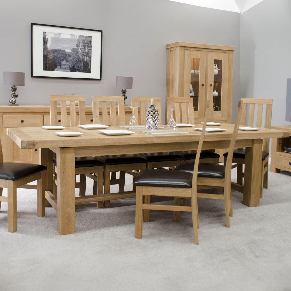 Oak dining table with eight chairs and padded seats in modern dining room setting