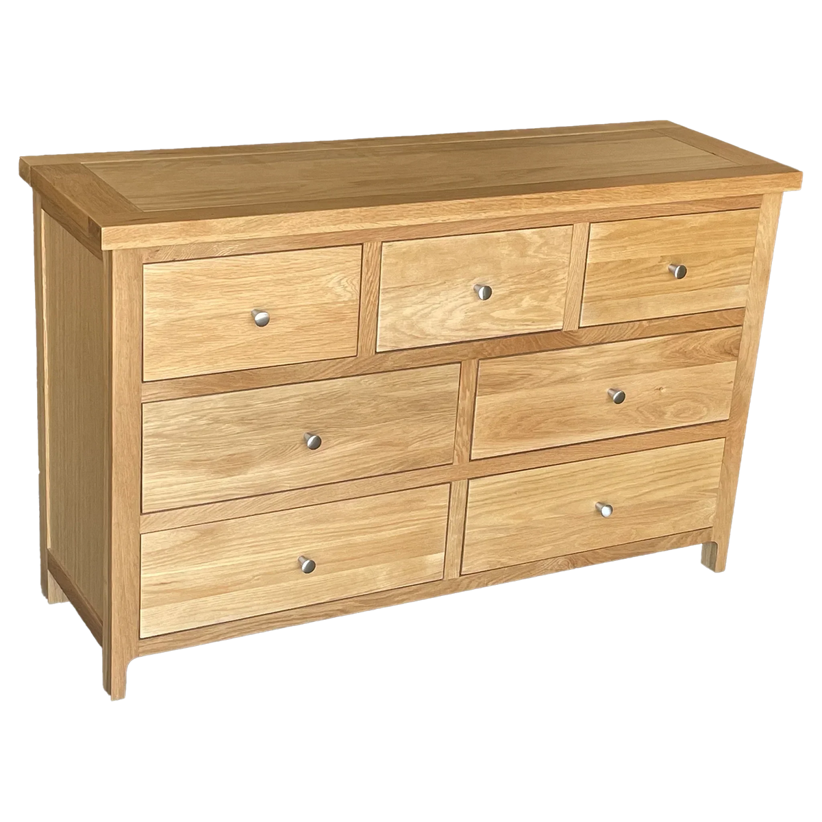 Oak chest of drawers with seven drawers and silver knobs, angled front view