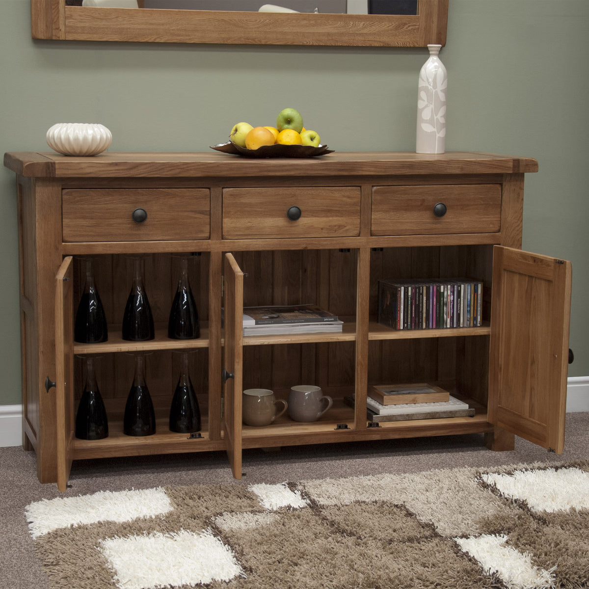 Rustic oak sideboard with three drawers, open cupboard doors, and shelving for storage