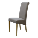 Upholstered dining chair with light wood legs and high backrest, side view