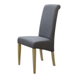 Grey dining chair with fabric upholstery and light wood legs, side view