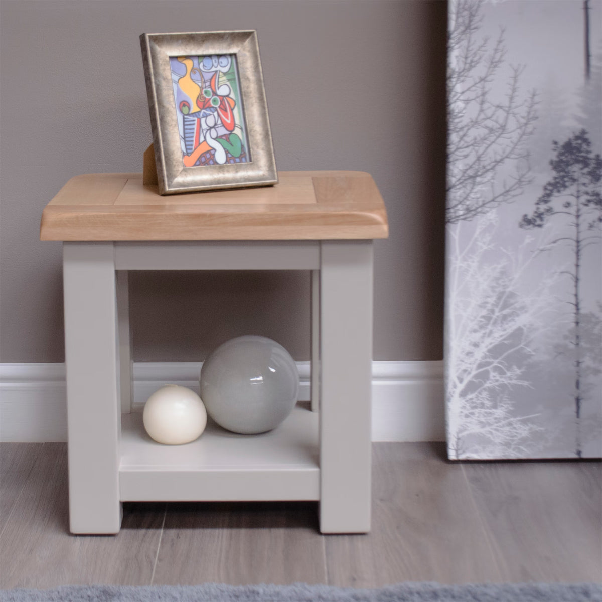 Oak and grey painted lamp table with shelf, framed art and decor spheres