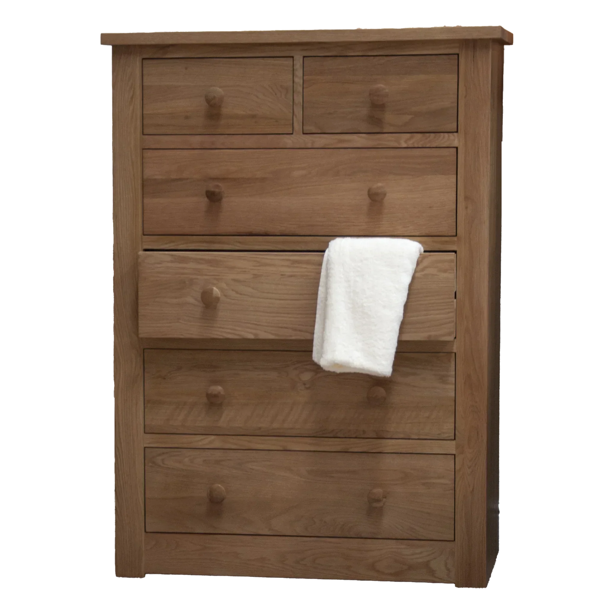 Oak chest of drawers with five large drawers and two small top drawers, white towel draped