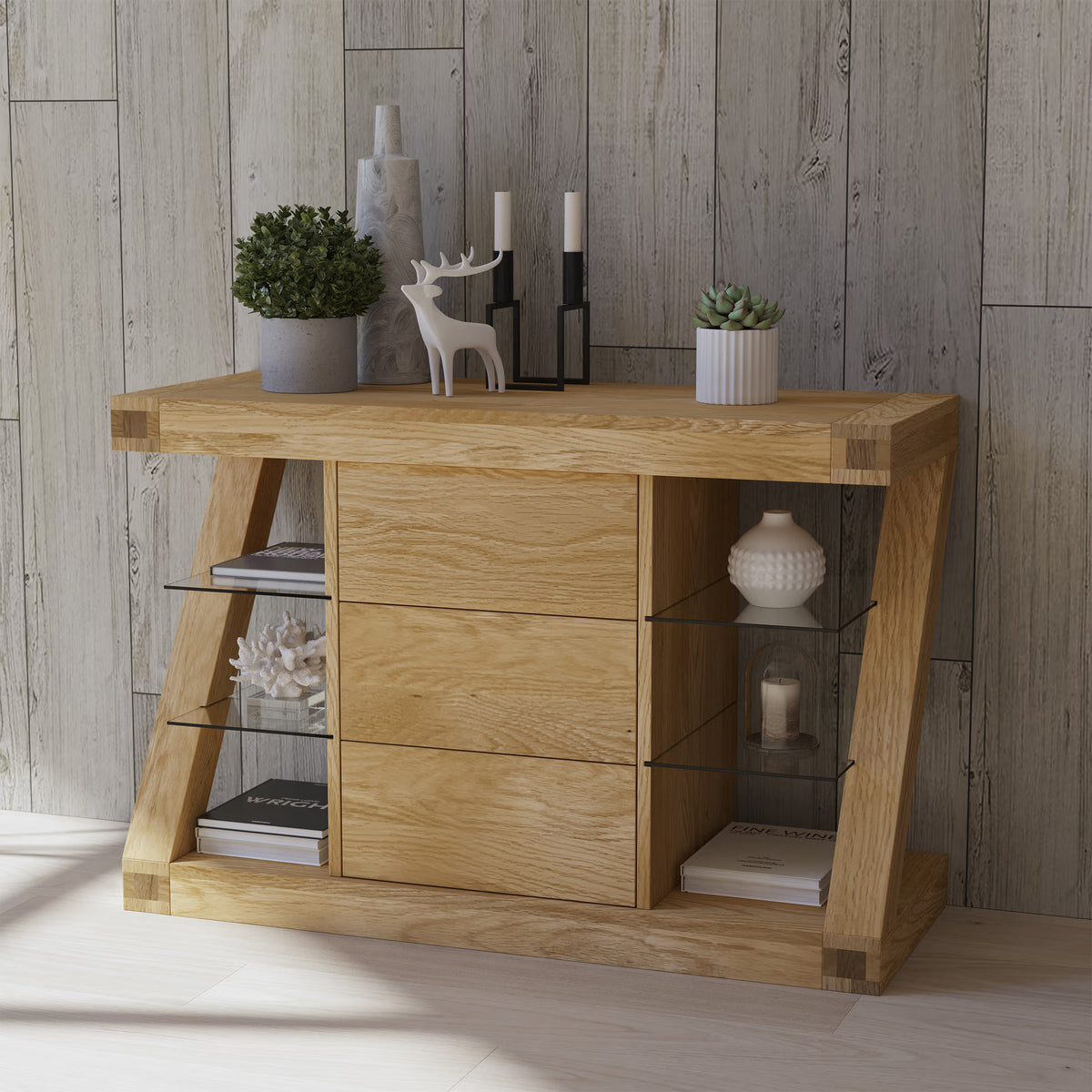Oak console table with glass shelves, decorative vases, and candles against wood panel wall