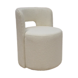Cream boucle accent chair with rounded back and modern cylindrical shape