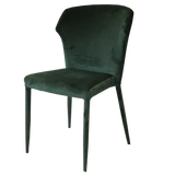 Green velvet dining chair with curved backrest and slim metal legs