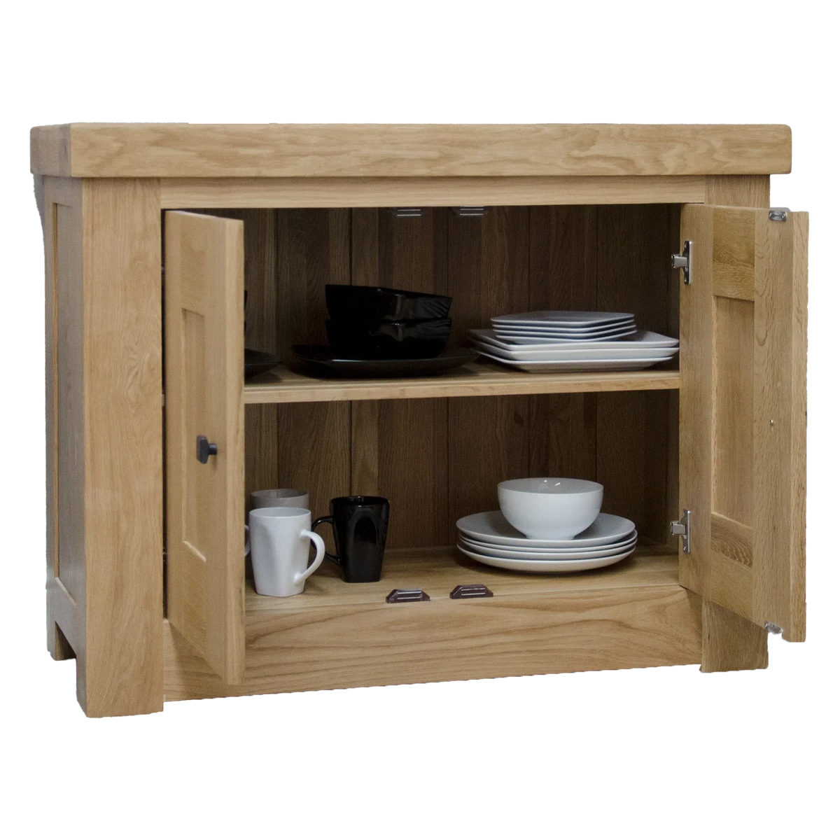 Oak sideboard with double doors open, displaying plates, bowls, and mugs on shelves