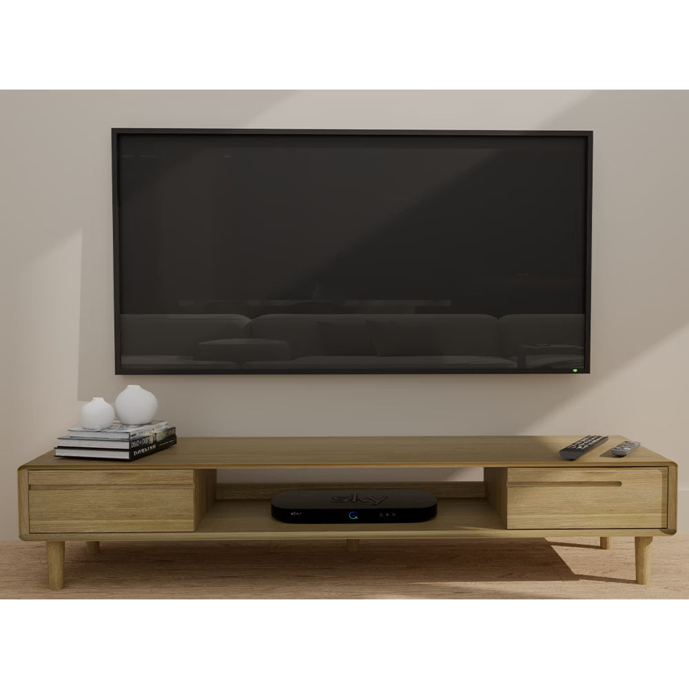 Oak TV unit with drawers and open shelf below wall-mounted television