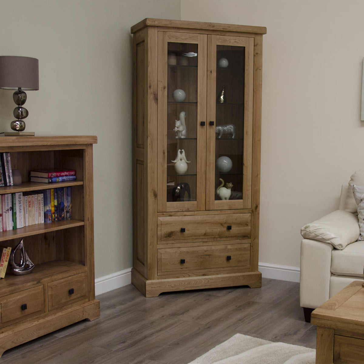 Oak display cabinet with glass doors and drawers in living room corner
