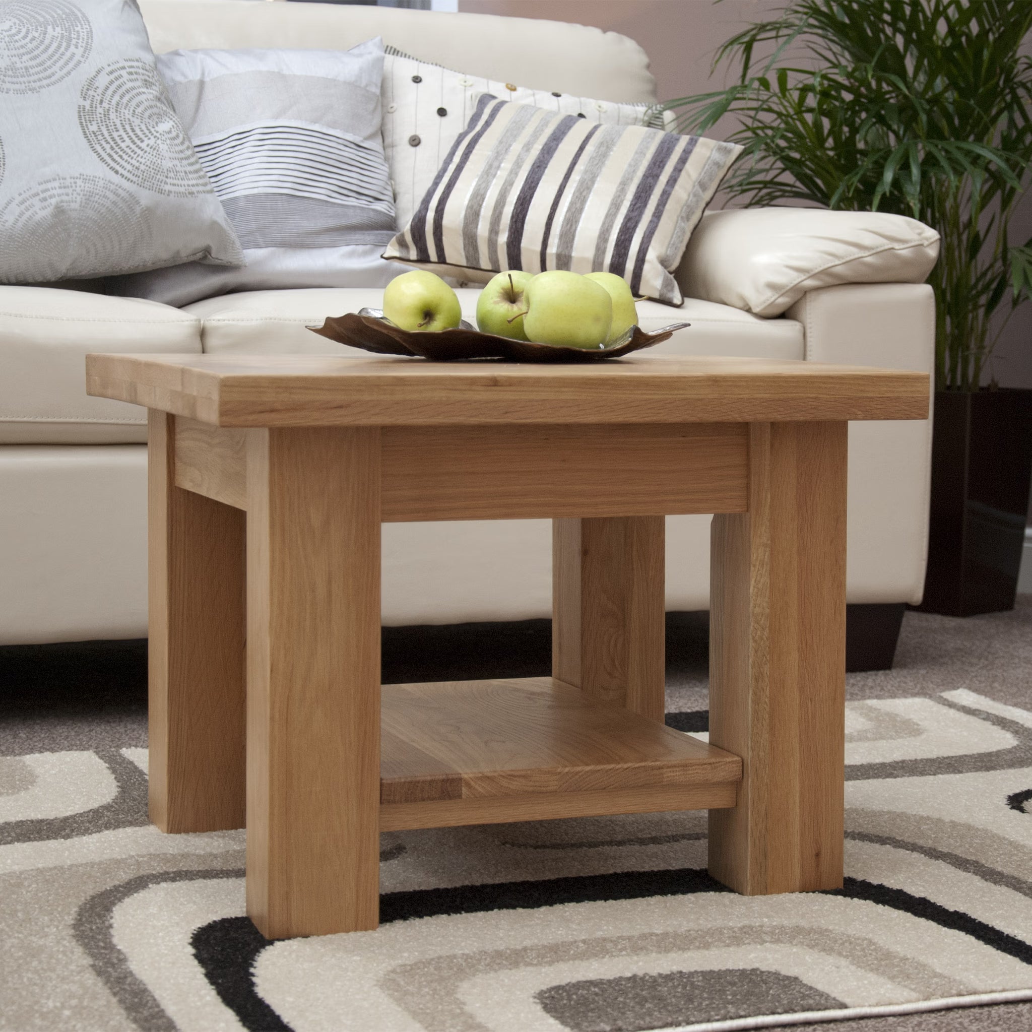 Solid oak coffee table with lower shelf, styled in a living room with neutral decor