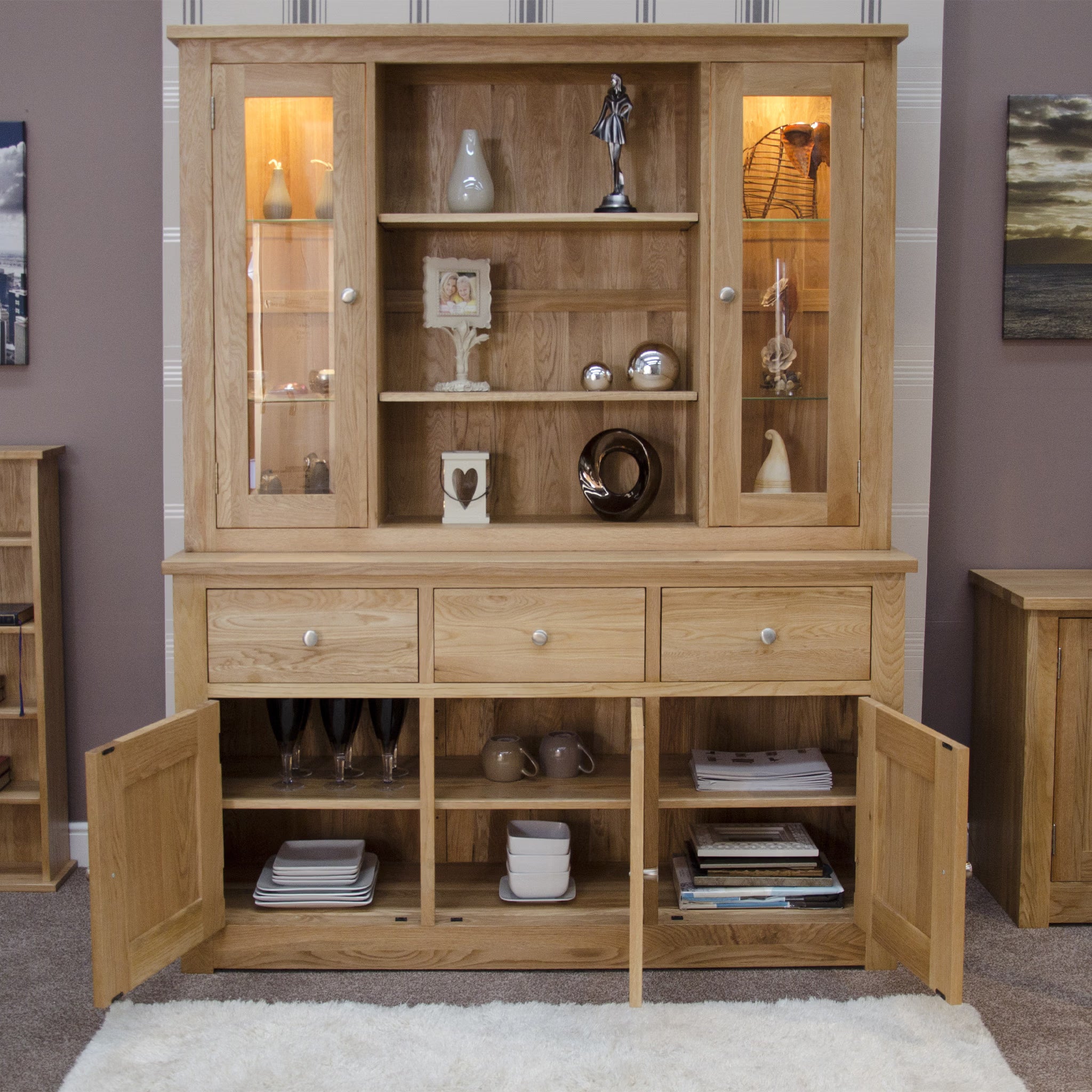 Oak sideboard dresser with glass doors, open shelving and storage drawers in living room