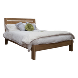 Wooden bed frame with headboard, white bedding, and decorative pillows