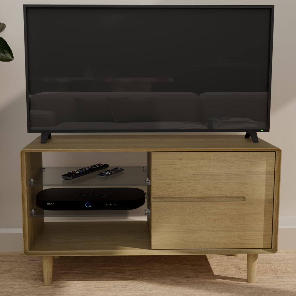 Oak TV unit with glass shelf, media box, remote controls and large flat screen TV on top