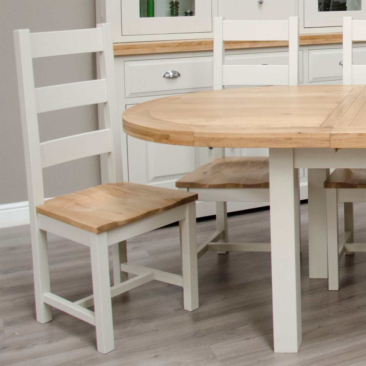 Oak dining table with matching wooden chairs in a modern kitchen setting