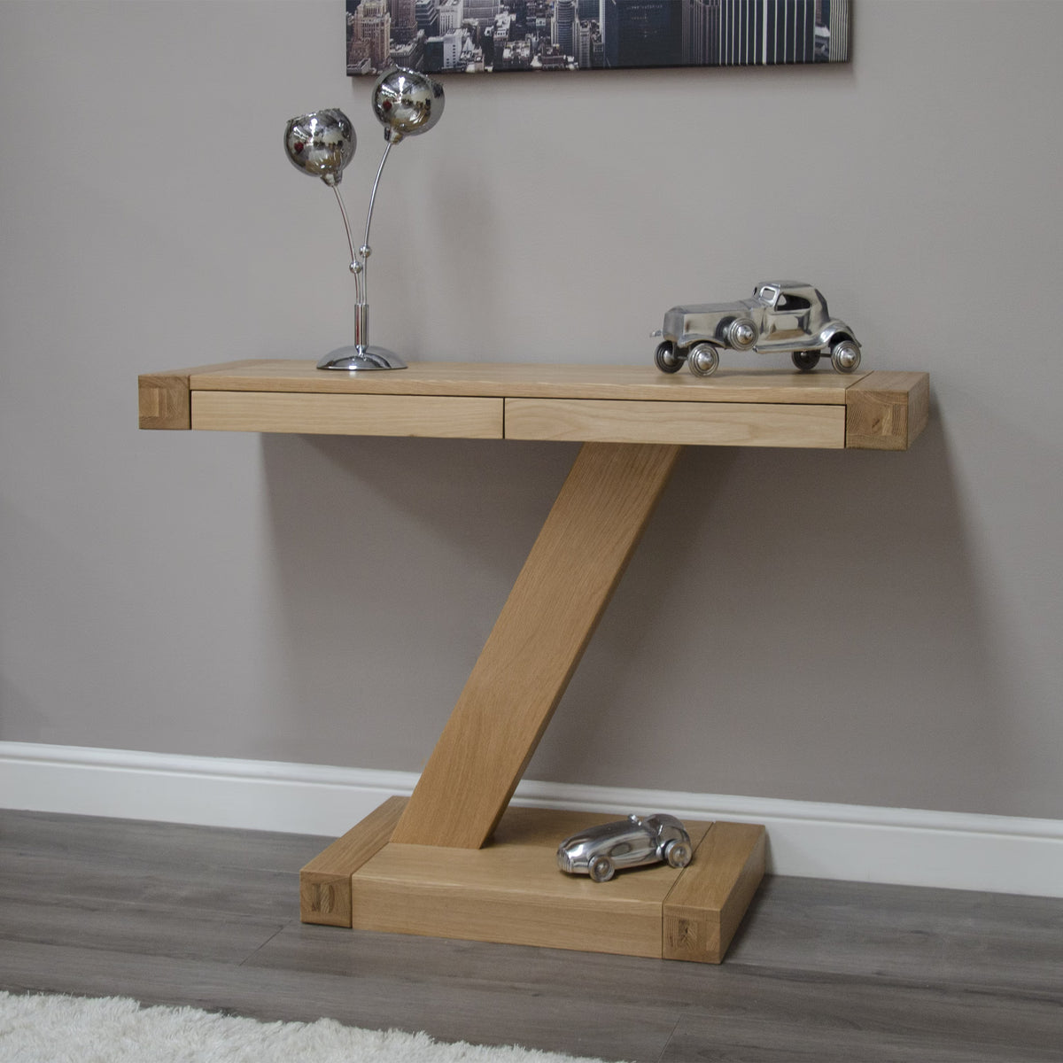 Oak console table with unique Z-shaped base, metal decor and toy car in modern hallway