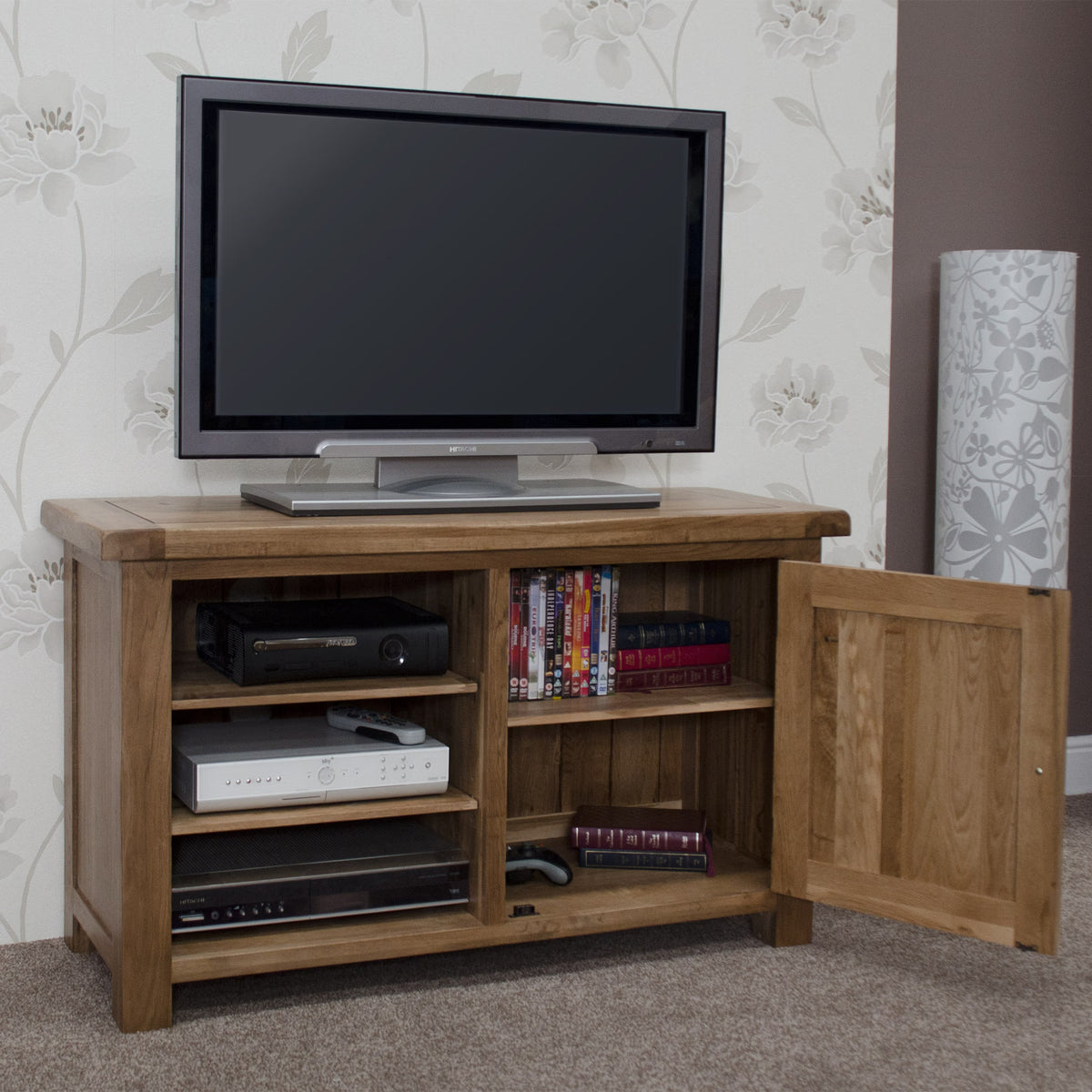 Oak TV unit with shelves, open cupboard, electronics and DVDs in living room setting