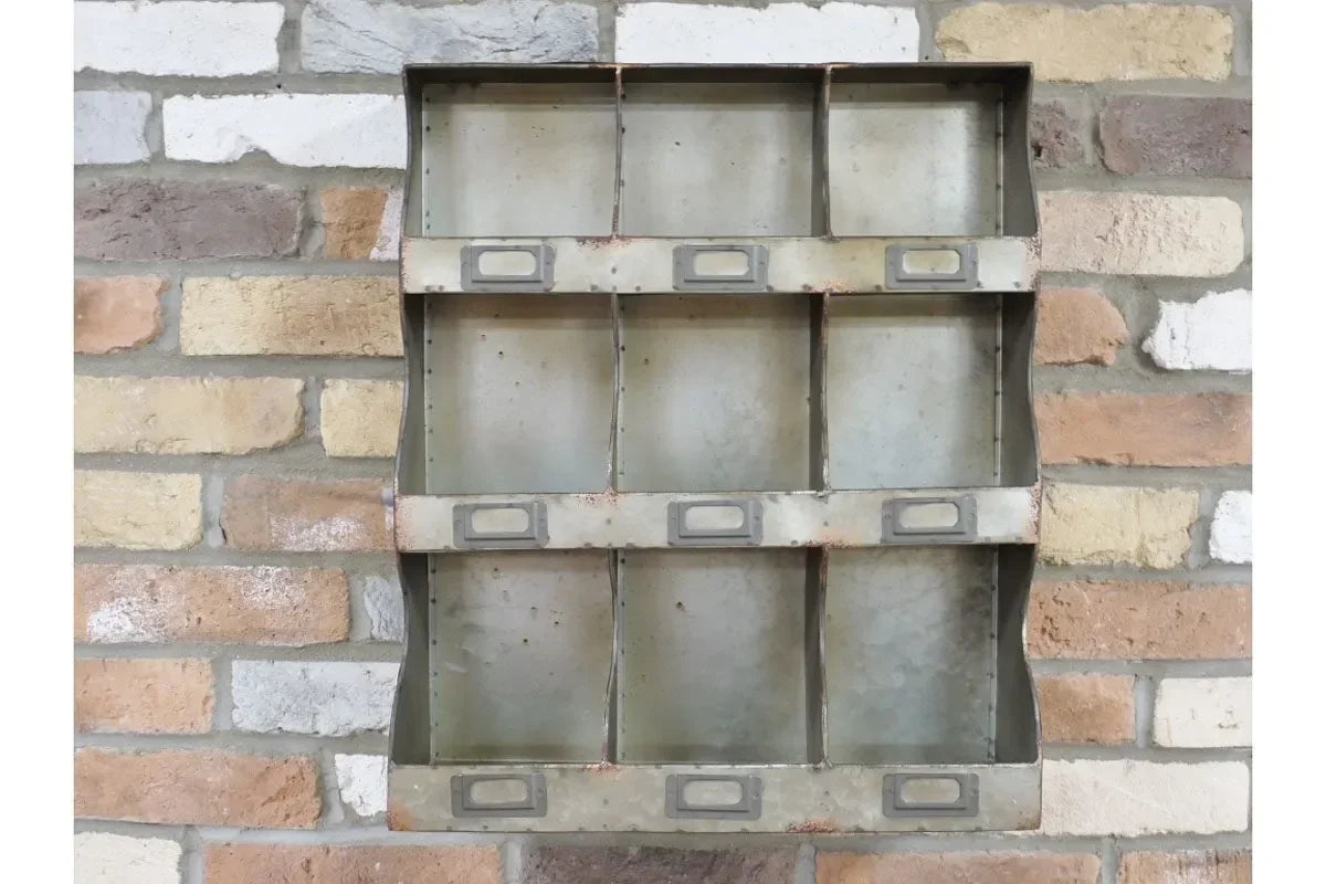 Industrial metal wall storage organiser with nine compartments mounted on brick wall