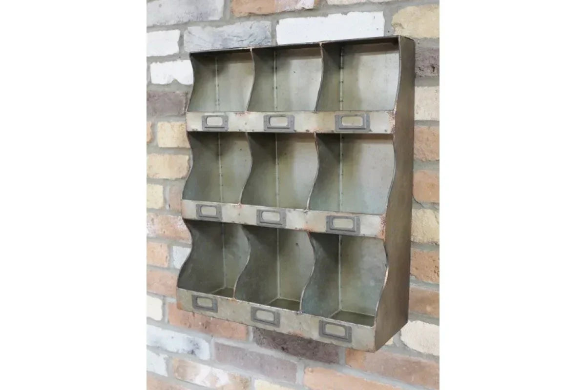 Industrial metal wall organiser with nine compartments mounted on brick wall