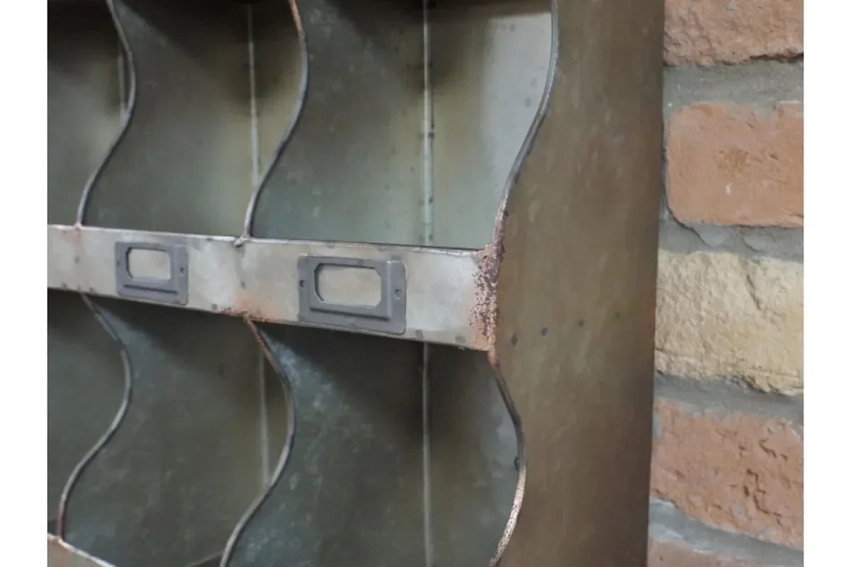 Closeup of industrial metal storage rack with divided shelves and label holders